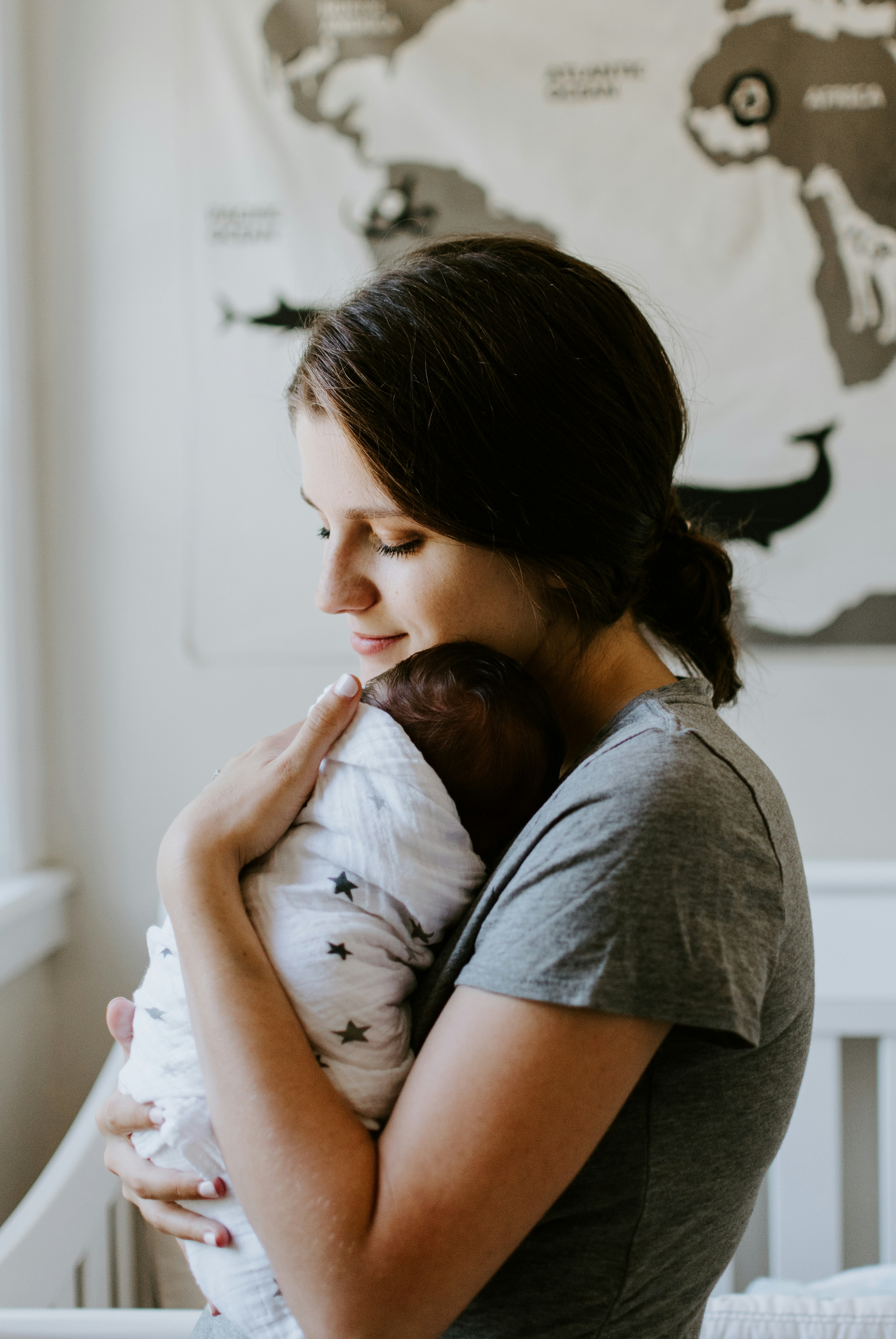 Mother holding her newborn close, a quiet moment of early postpartum life in Northern Virginia
